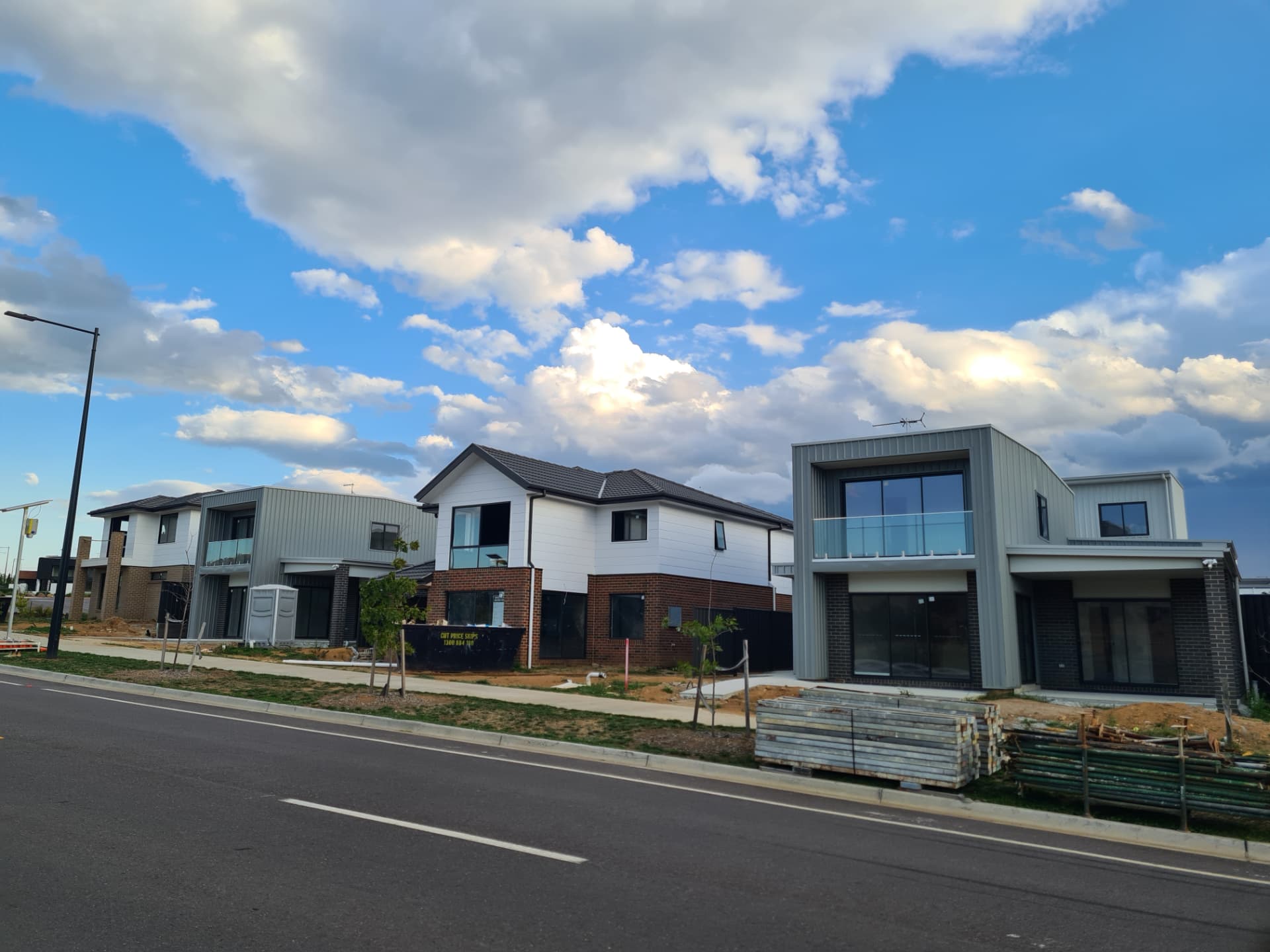 Row of new estate homes with face brick lower storeys