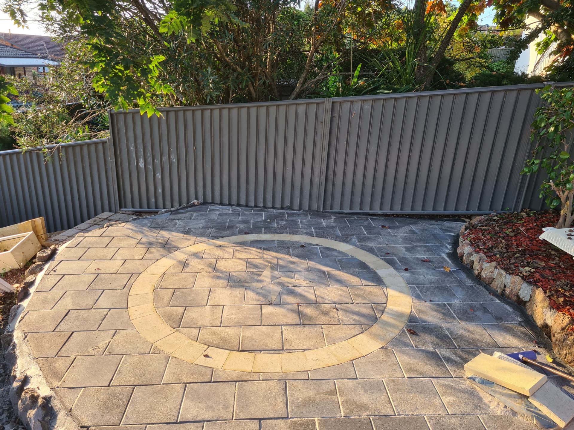 Paved courtyard with a circular sandstone feature inlay