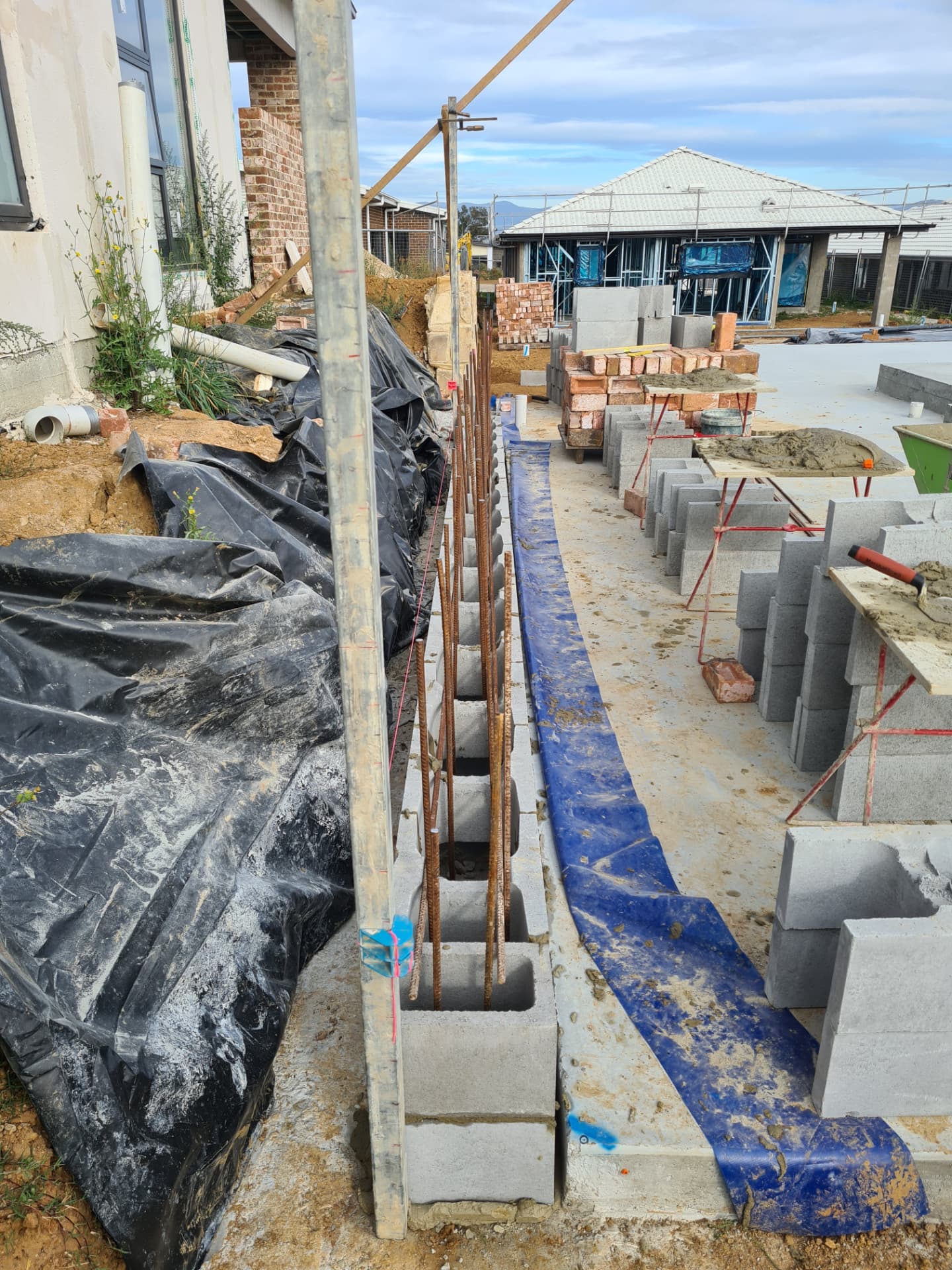 Core filled block retaining wall with steel starter bars on a new build site